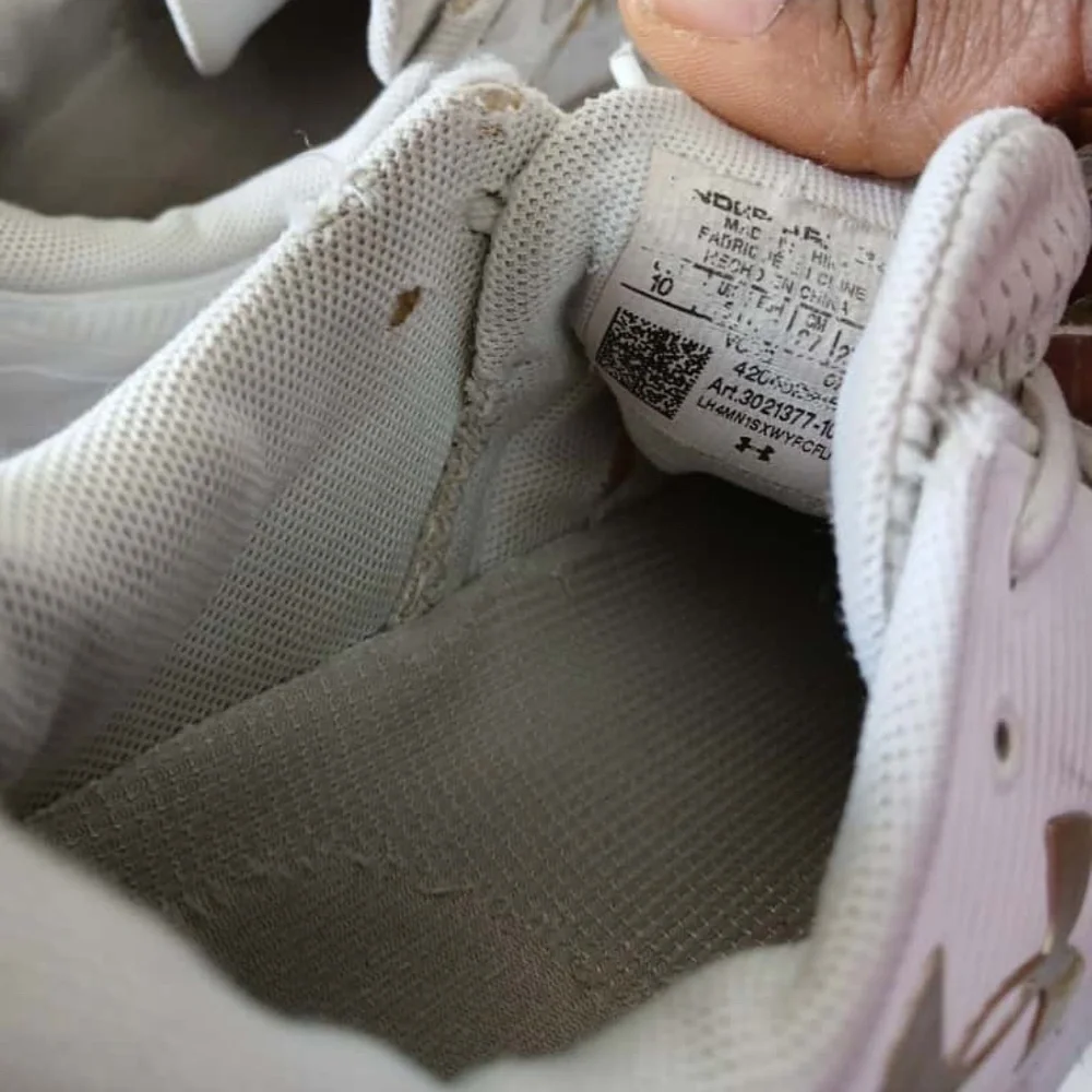 Under Armour White Sneakers with Gold Accents Size 10.